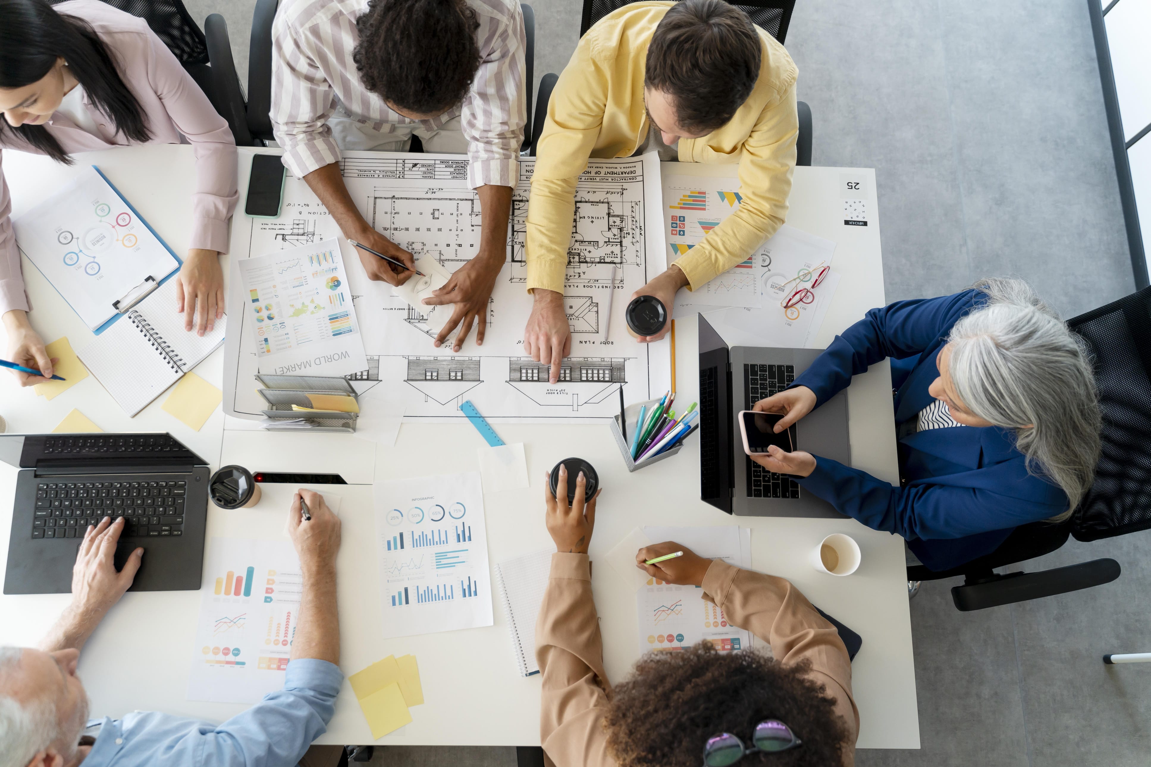business people meeting around table with charts